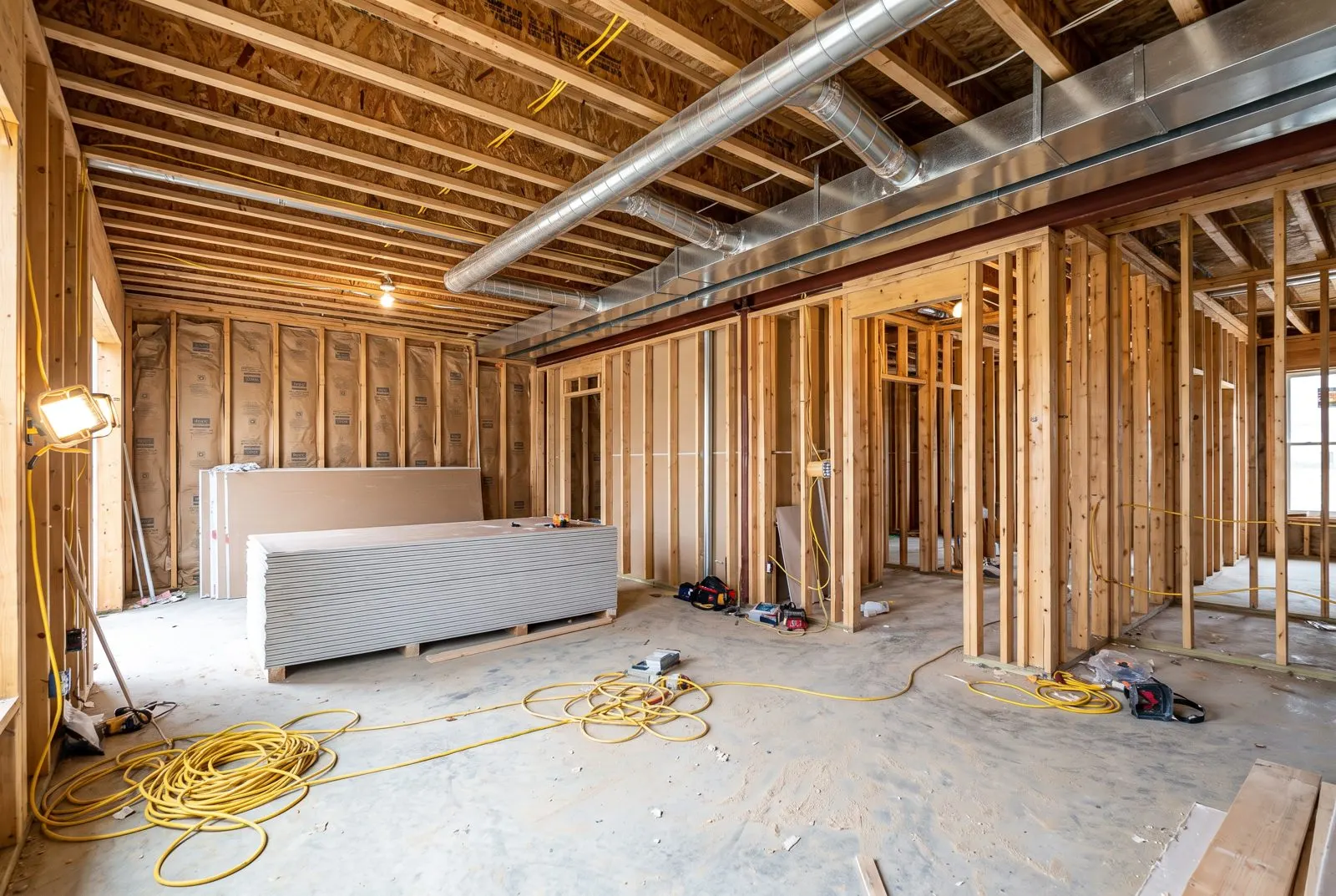 Home renovation with open studs and new ductwork overhead